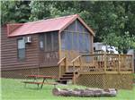 One of the rustic cabin rentals with a deck at FORT WILDERNESS CAMPGROUND AND RV PARK - thumbnail