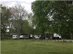 A row of trailers backed in at J & J RV PARK - thumbnail