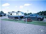 A truck and trailer in a gravel RV site at TRAVELER'S WORLD RV PARK - thumbnail