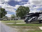 View larger image of A row of paved RV sites at BENCHMARK COACH AND RV PARK image #7