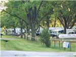 Wooden fence with RVs parked on the other side at PARK RIDGE RV CAMPGROUND - thumbnail