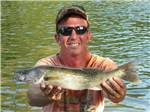 Man showing off catch of the day at BSC OUTDOORS CAMPING & FLOAT TRIPS - thumbnail