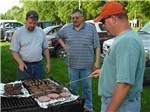 Men grilling quality meats at BSC OUTDOORS CAMPING & FLOAT TRIPS - thumbnail