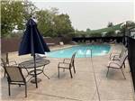 Chairs around the swimming pool at AUBURN GOLD COUNTRY RV PARK - thumbnail