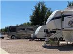RVs in gravel sites on sunny day at DE ANZA RV RESORT - thumbnail