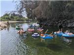 People floating down the river on inner tubes at KINGS RIVER RV RESORT - thumbnail