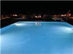 The swimming pool lit up at night at KINGS RIVER RV RESORT - thumbnail