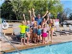 A group of kids celebrating by the pool at KINGS RIVER RV RESORT - thumbnail