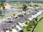 RVs parked along a paved road near pond at THE CREEKS GOLF & RV RESORT - thumbnail