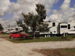 Fifth wheel and red car parked at site at ASHLAND/HUNTINGTON WEST KOA HOLIDAY - thumbnail