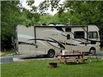 A picnic table next to a motorhome at RIFRAFTERS CAMPGROUND - thumbnail