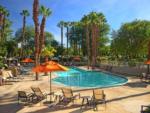 The swimming pool with lounge chairs at EMERALD DESERT RV RESORT - thumbnail