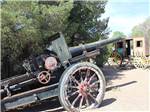 An old black cannon next to a tree at BILLY THE KID MUSEUM - thumbnail
