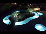 An aerial view of the lazy river at night at TWELVE OAKS RV PARK - thumbnail
