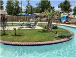 A view of the lazy river at TWELVE OAKS RV PARK - thumbnail