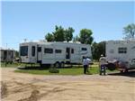 People standing behind a trailer at COUNTY LINE RV PARK & CAMPGROUND - thumbnail