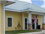A yellow building with an American flag - thumbnail