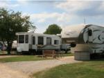 Two RVs parked in gravel sites at LEISURE LAKE RESORT - thumbnail