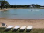 Lounge chairs on the beach at LEISURE LAKE RESORT - thumbnail