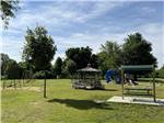 Swings and a gazebo in the grass at SOMERSET BEACH CAMPGROUND & RETREAT CENTER - thumbnail