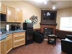 View larger image of Sink fridge fireplace and TV in one room at DESERT GEM RV RESORT image #3