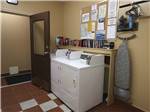 View larger image of Washer and dryer with bookshelf and bulletin board at DESERT GEM RV RESORT image #5