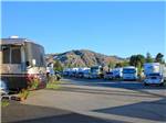 View larger image of RVs in sites with rugged mountain backdrop at DESERT GEM RV RESORT image #10