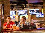 View larger image of A couple of guys drinking beer in the sports bar at LITTLE RIVER CASINO RESORT RV PARK image #4