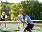 A group of people playing pickleball - thumbnail