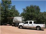 View larger image of A truck and travel trailer in an RV site at PAYSON CAMPGROUND AND RV RESORT image #8