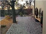 View larger image of A stone paver patio with a bench at PAYSON CAMPGROUND AND RV RESORT image #9