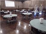 Round tables inside of the event center at HEARTLAND RV PARK & CABINS - thumbnail