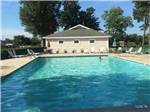 Pool area with lounge chairs at Tranter's Creek Resort & Campground - thumbnail