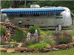 View larger image of Trailer parked in front of a garden area at RIVERSIDE RV PARK image #1