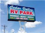 View of the tall park sign from below at CEDAR VALLEY RV PARK - thumbnail