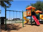 The swing set at the playground at GULF COAST RV RESORT - thumbnail