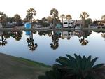 Lake view with parked trailer's at site Gulf Waters Beach Front RV Resort - thumbnail