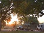 View larger image of A view of the RV sites thru trees at PECAN PARK RIVERSIDE RV PARK image #1