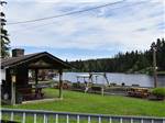 A pavilion and swing by the lake at RAINBOW RV RESORT - thumbnail