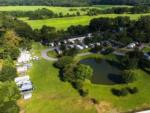 Aerial shot of pond and RV sites at Winners Circle RV Resort - thumbnail
