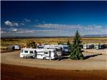 Aerial view of multiple RVs parked on dirt road at BLUE MOUNTAIN RV AND TRADING - thumbnail