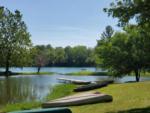 Canoes on the grass by the water - thumbnail