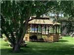 A wood gazebo with carved bears on it at TURAH RV PARK - thumbnail
