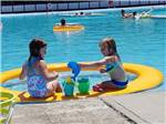 A couple of girls playing in the swimming pool at MOUNTAIN PINES CAMPGROUND - thumbnail