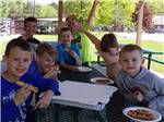 View larger image of A bunch of kids eating pizza at MOUNTAIN PINES CAMPGROUND image #7