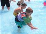 View larger image of Kids playing on the shallow end of the pool at MOUNTAIN PINES CAMPGROUND image #8