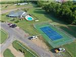 View larger image of Aerial view of pool and tennispickleball court at BLUEBONNET RIDGE RV PARK  COTTAGES image #4
