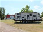 A travel trailer at a site - thumbnail