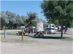 Gravel sites lined with trees at NORTH PARK RV CAMPGROUND - thumbnail