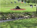 A water fountain and flag poles at FOX DEN ACRES CAMPGROUND - thumbnail